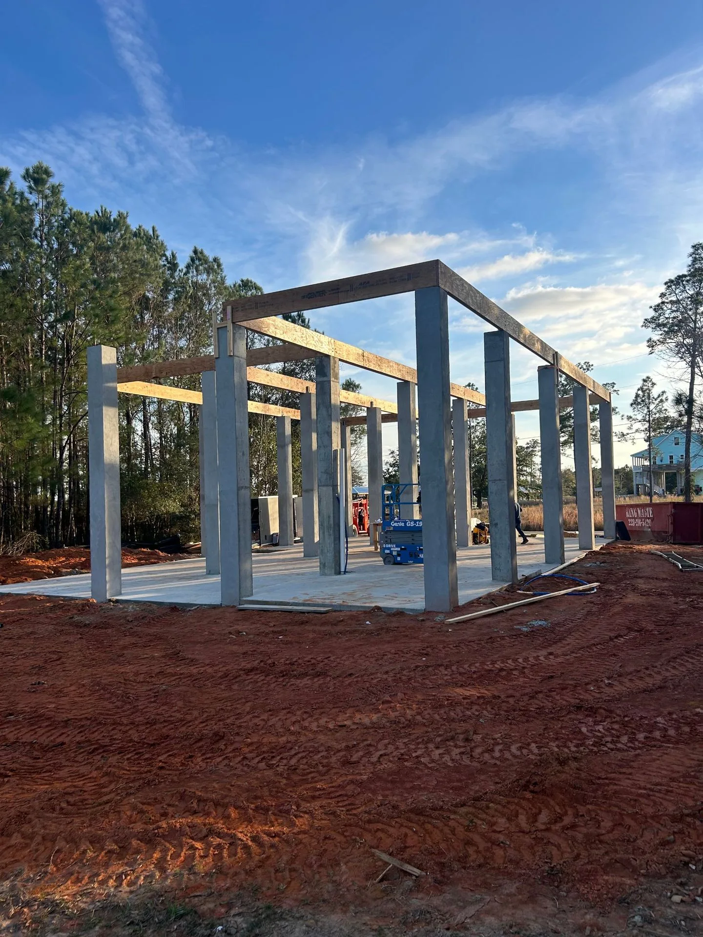 Wood beams set on concrete pilings for an elevated home by 3H Construction