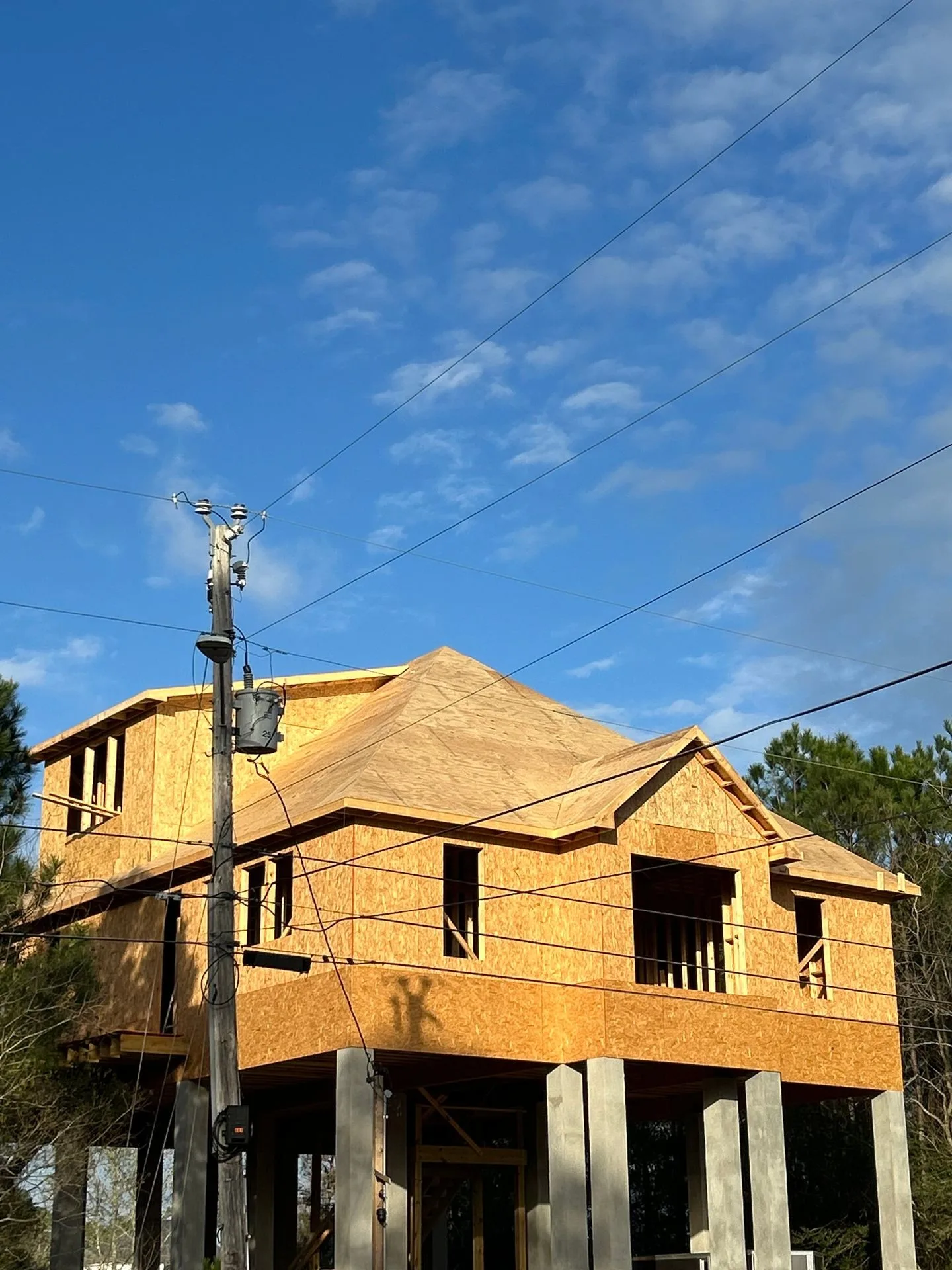 Decked roof on a framed elevated custom home by 3H Construction