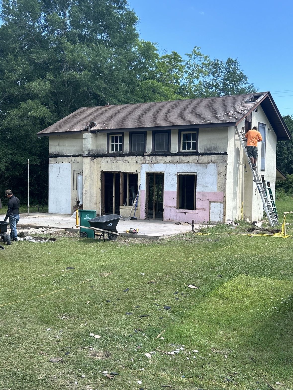 Demolition of an old home addition, exposed framing and crew at work