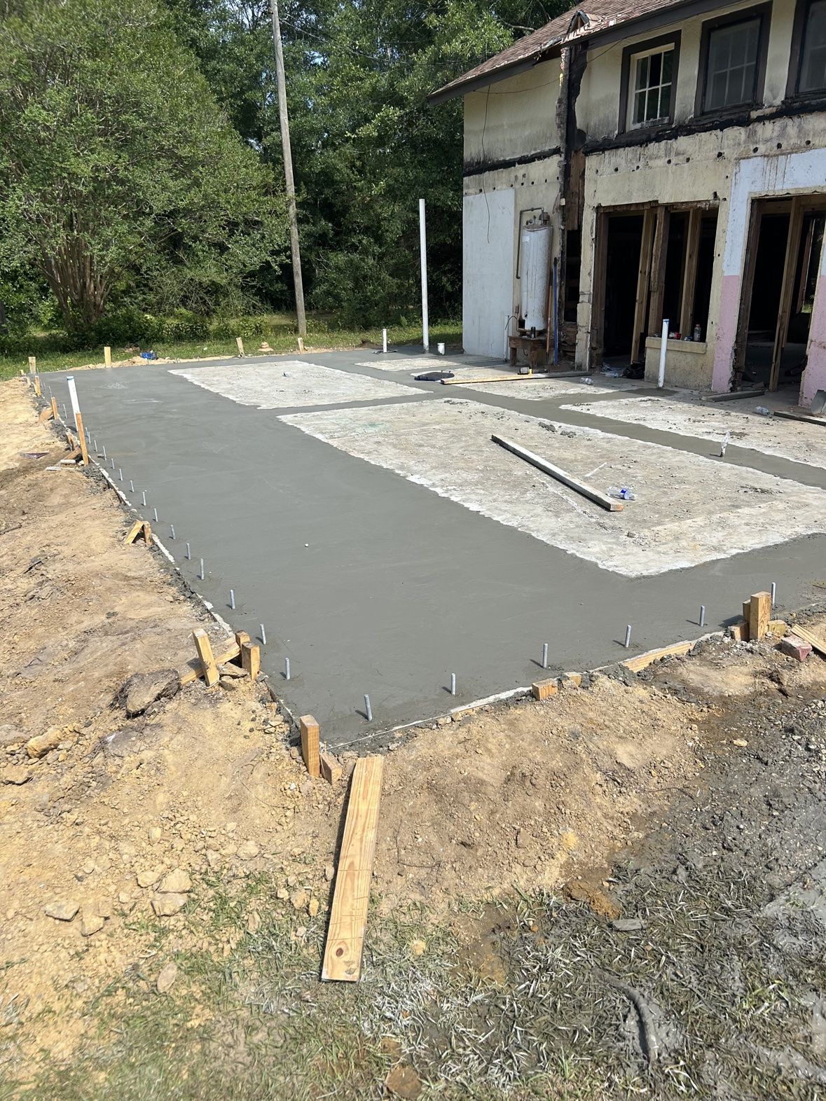 Freshly poured concrete slab foundation for a home addition