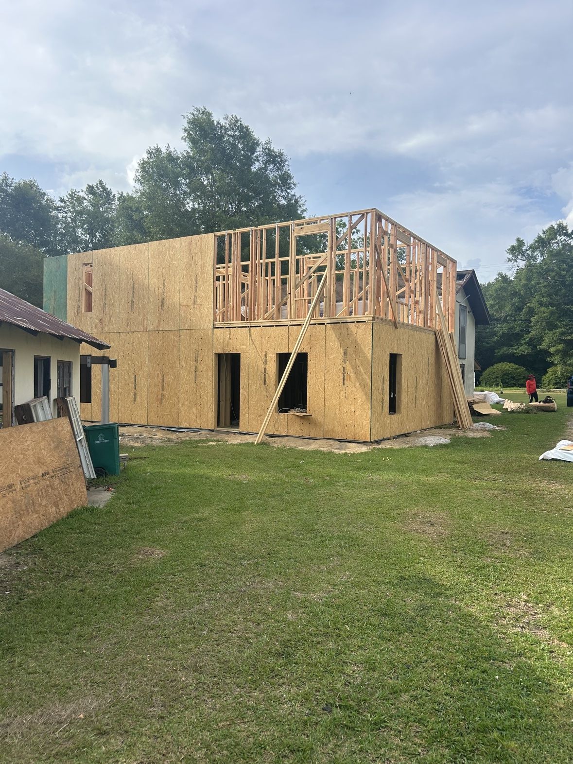 Two-story framed home addition with sheathing being installed