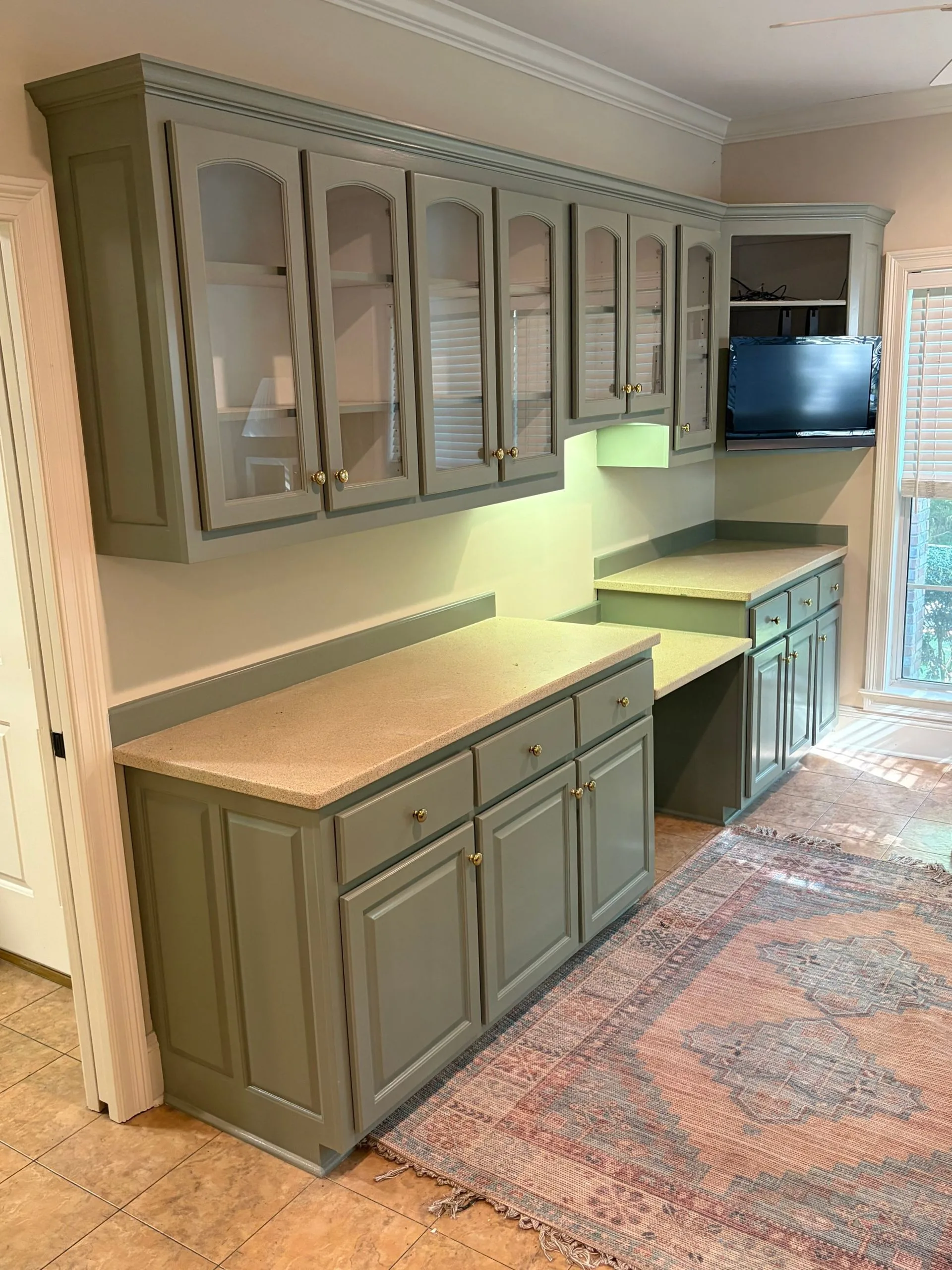 Office cabinets repainted sage green by 3H Construction