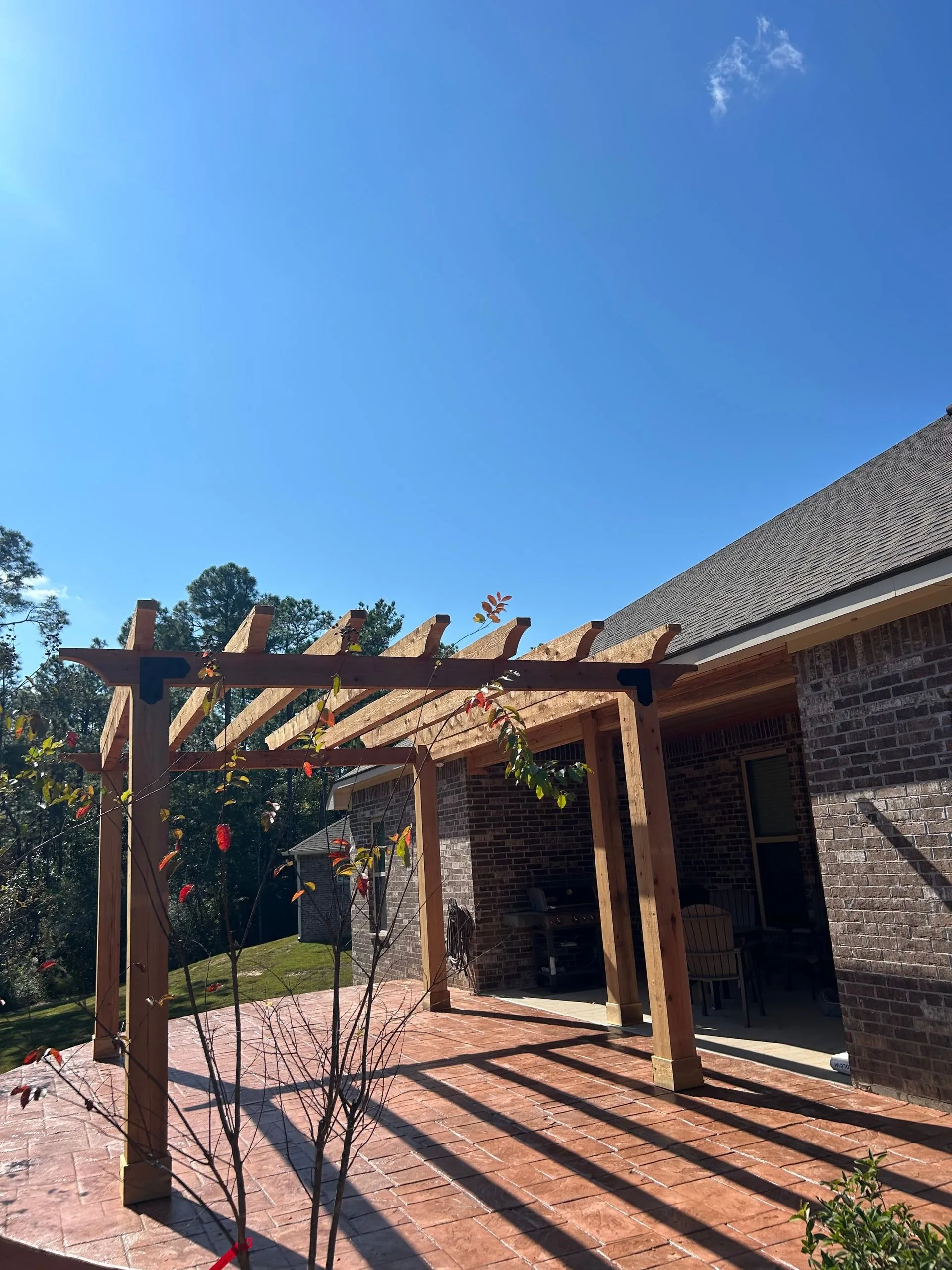 Cedar pergola over brick patio by 3H Construction