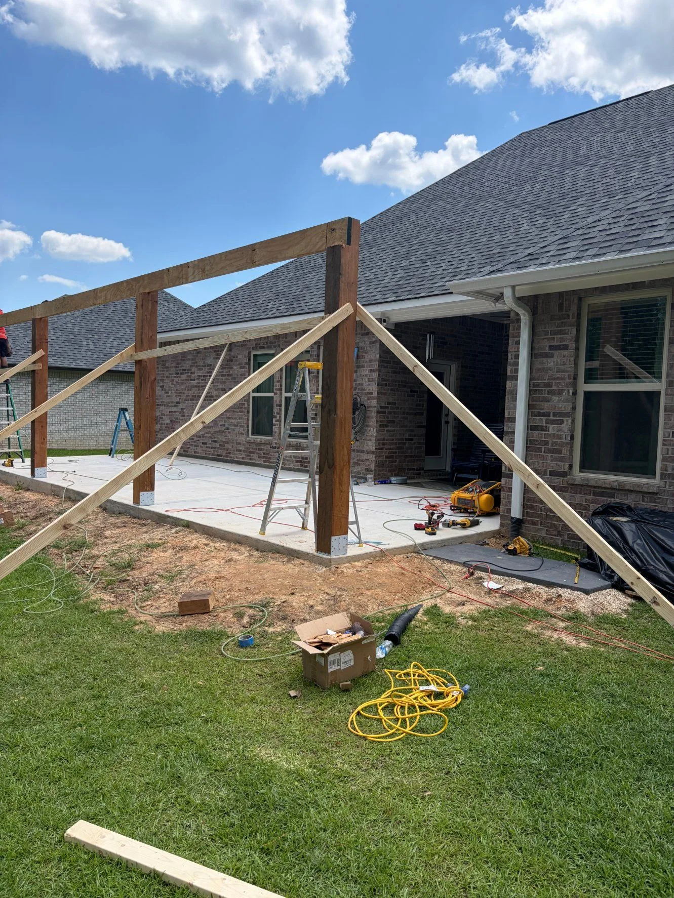 Porch post and beam framing with temporary bracing by 3H Construction