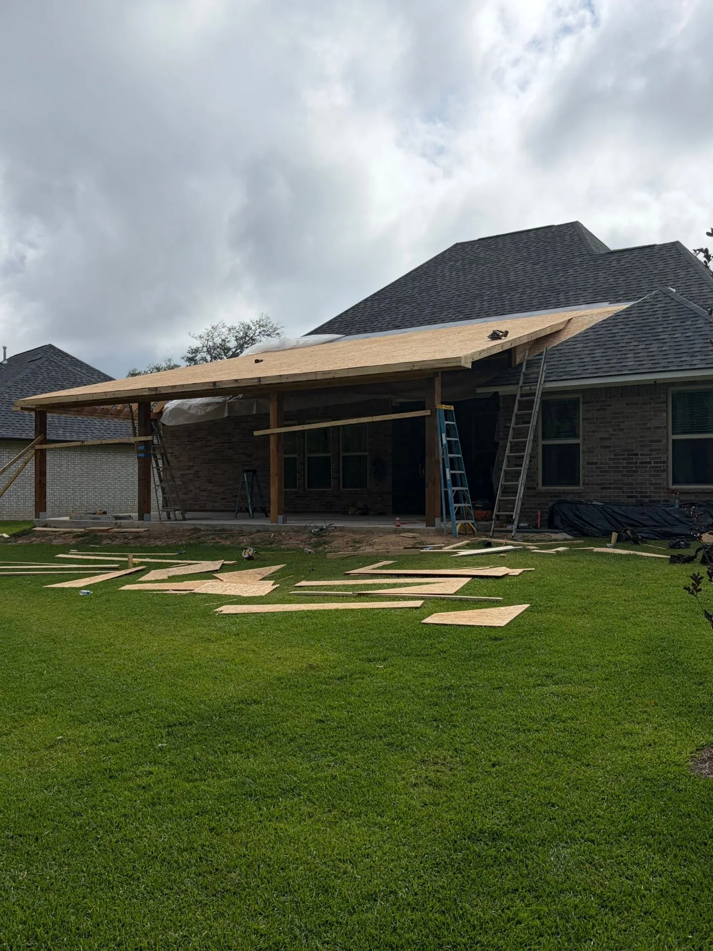 Roof decking being installed on porch roof framing by 3H Construction