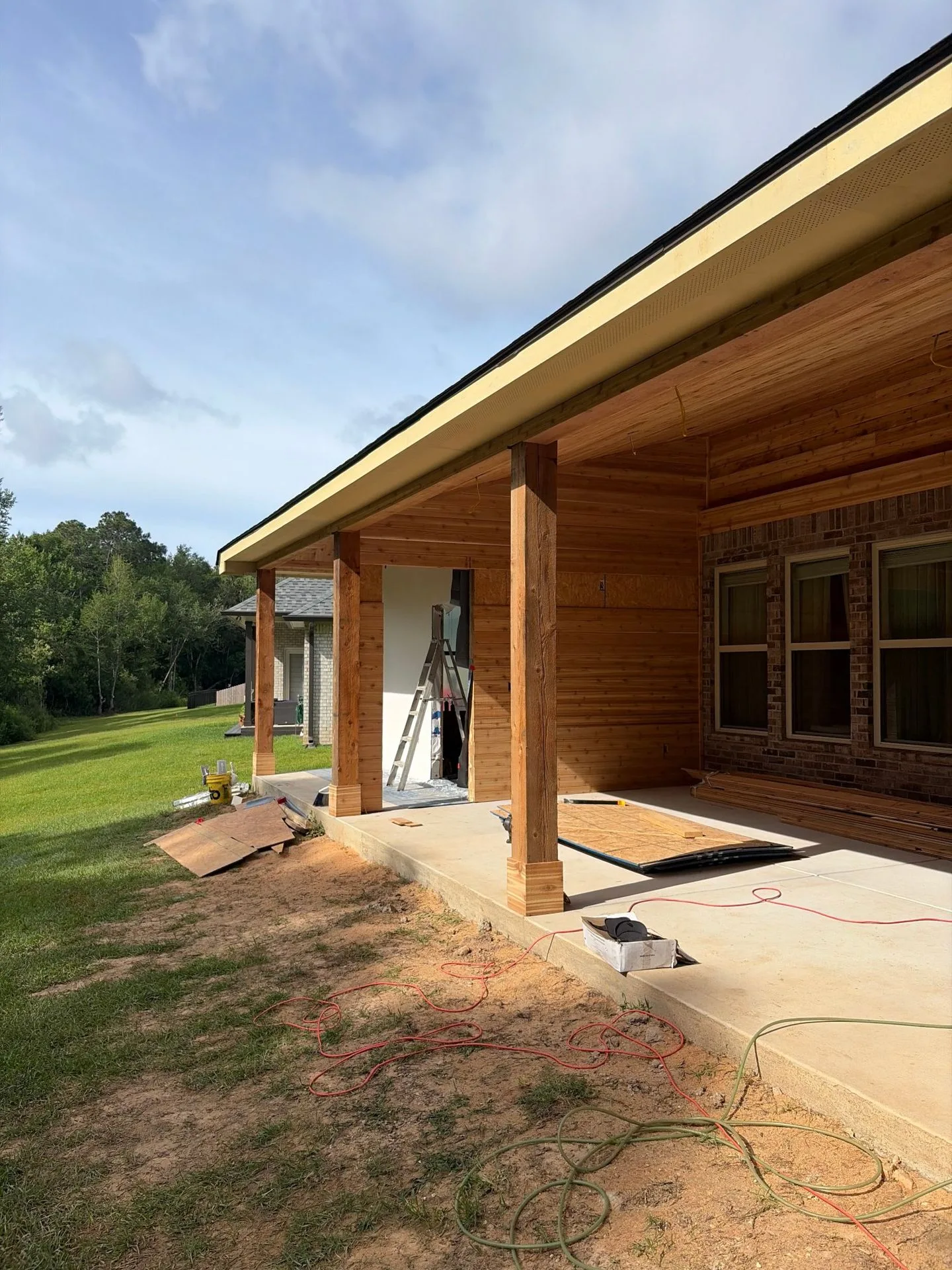 Cedar tongue-and-groove porch ceiling being installed by 3H Construction