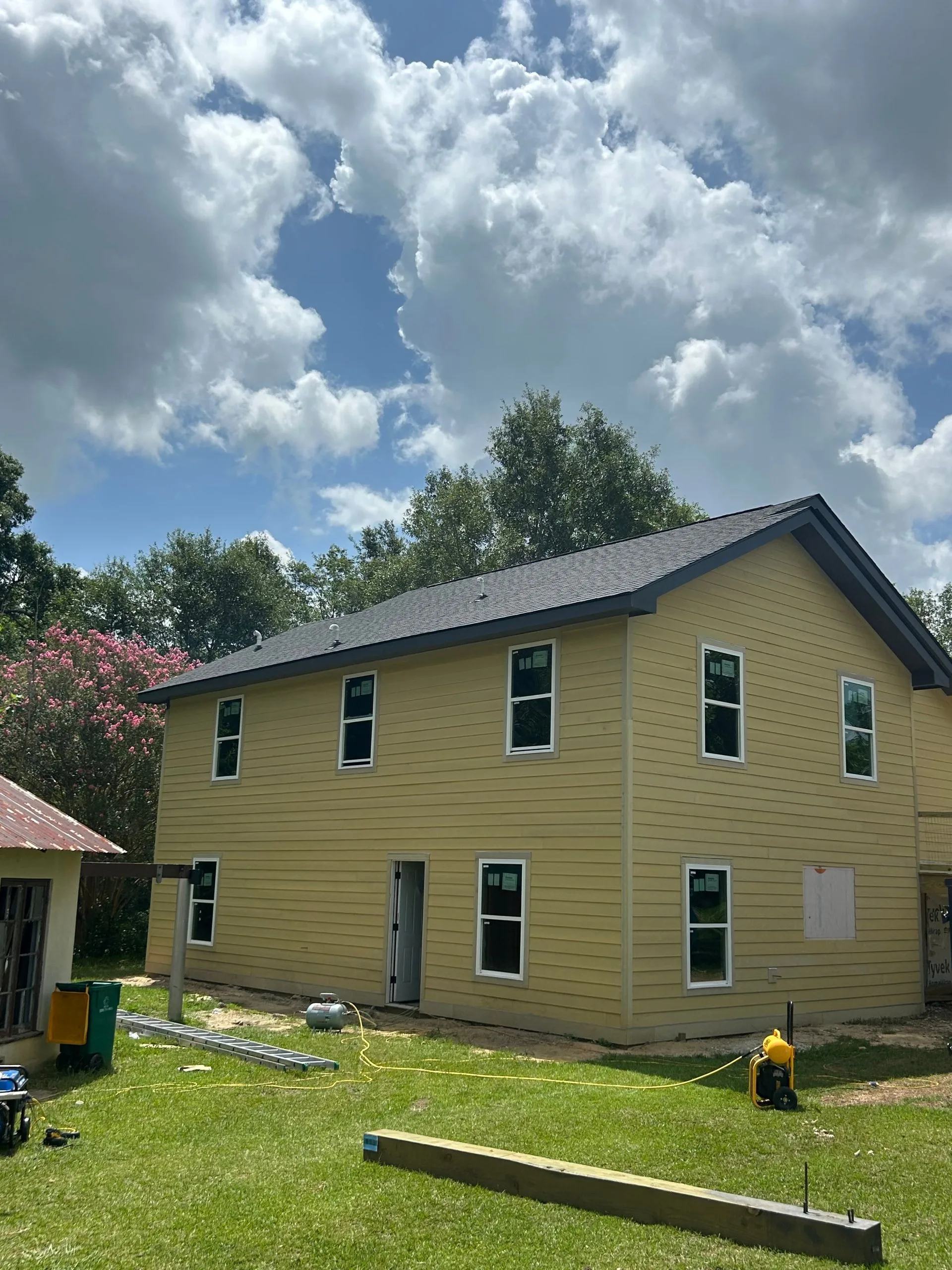 Two-story home exterior with siding and new windows by 3H Construction